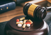 Gavel next to drugs on a desk